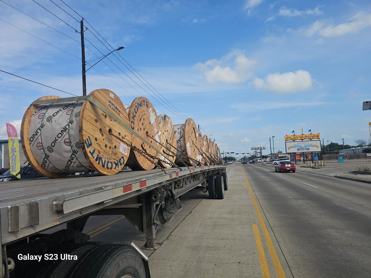 Cable reels secured on a flatbed trailer