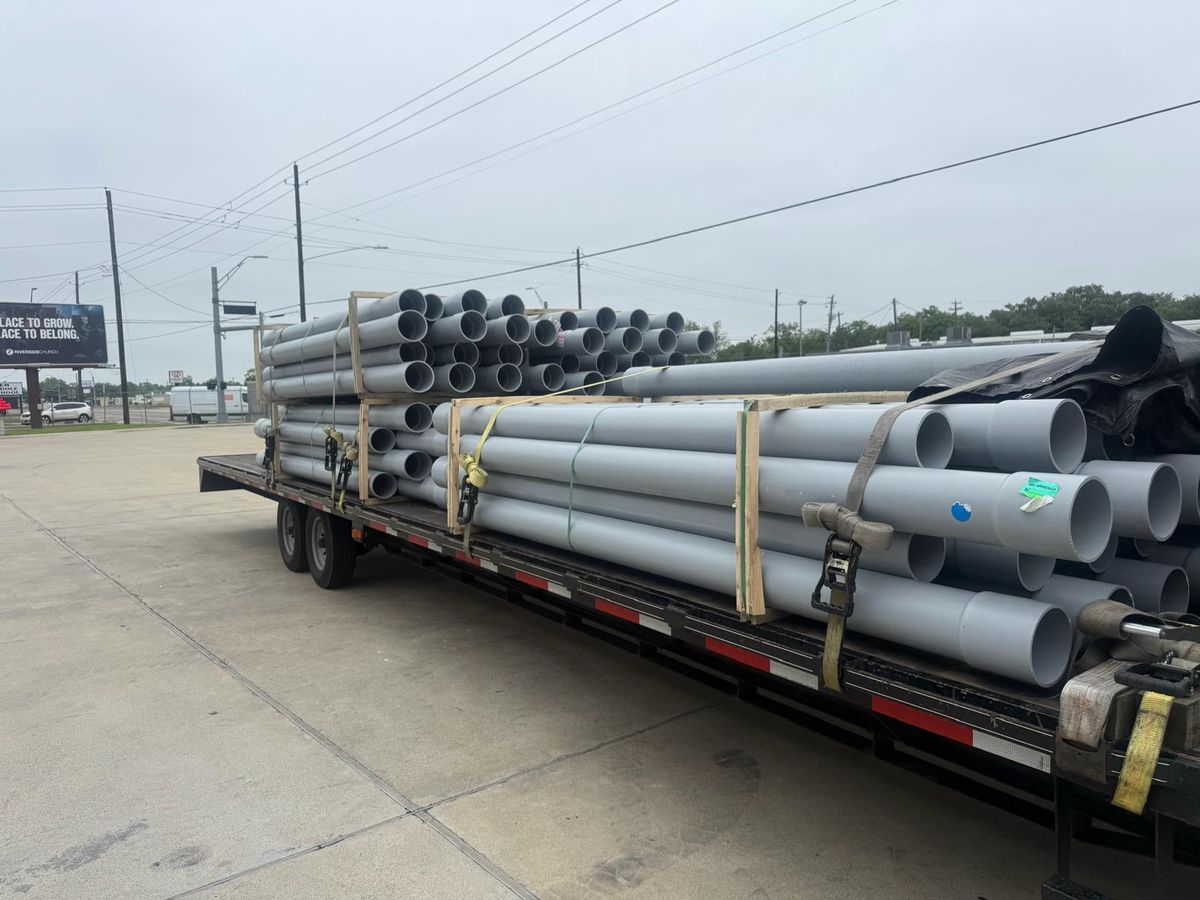 Stacked pipe secured on a flatbed
